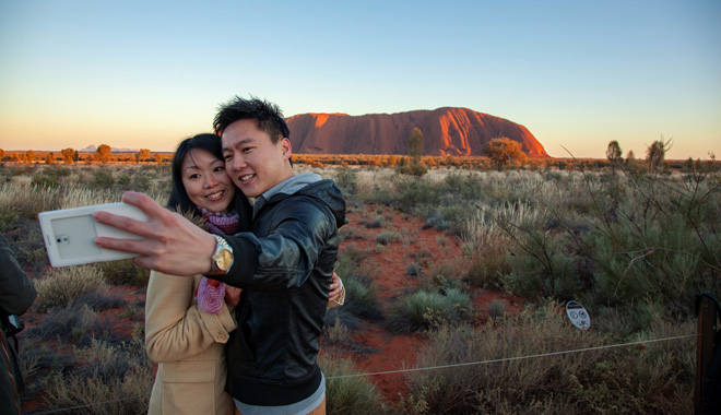 Asian couple taking a selfie at at Uluru