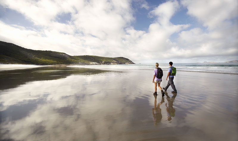 Couple walking along beach in Wilsons Promontory National Park