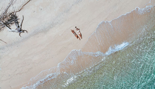 Aerial image of two young women on the Frankland Islands