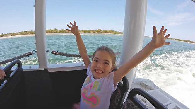 happy girl on aquaduck airlie beach jpg