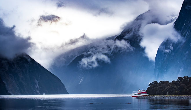 tourist boat cruising in milford sound fjordland national park
