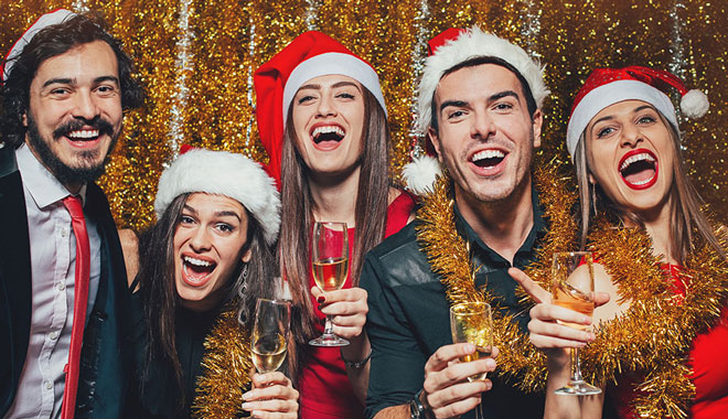 Group of people with Santa hats celebrating
